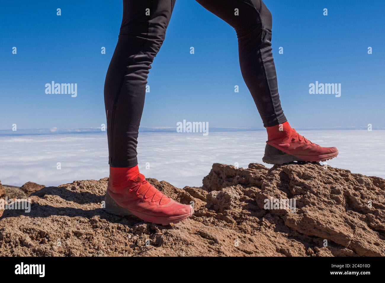 Successful runner hiker enjoy the view on mountain top cliff edge Stock Photo