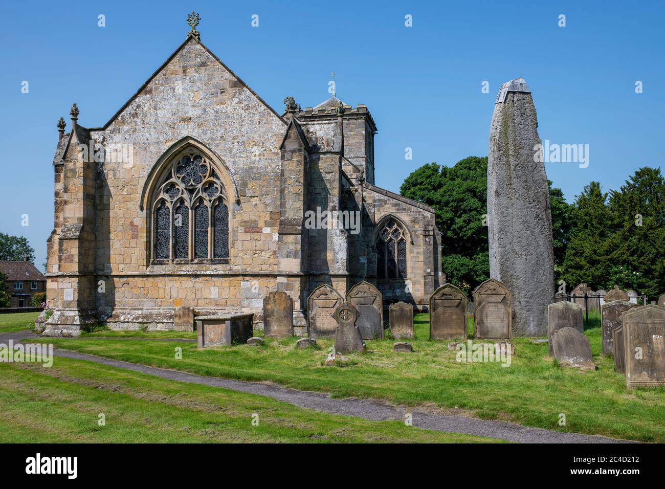 All Saints church beside the tallest (25 feet) Monolithic stone in GB, Rudston, East Yorkshire, UK Stock Photo