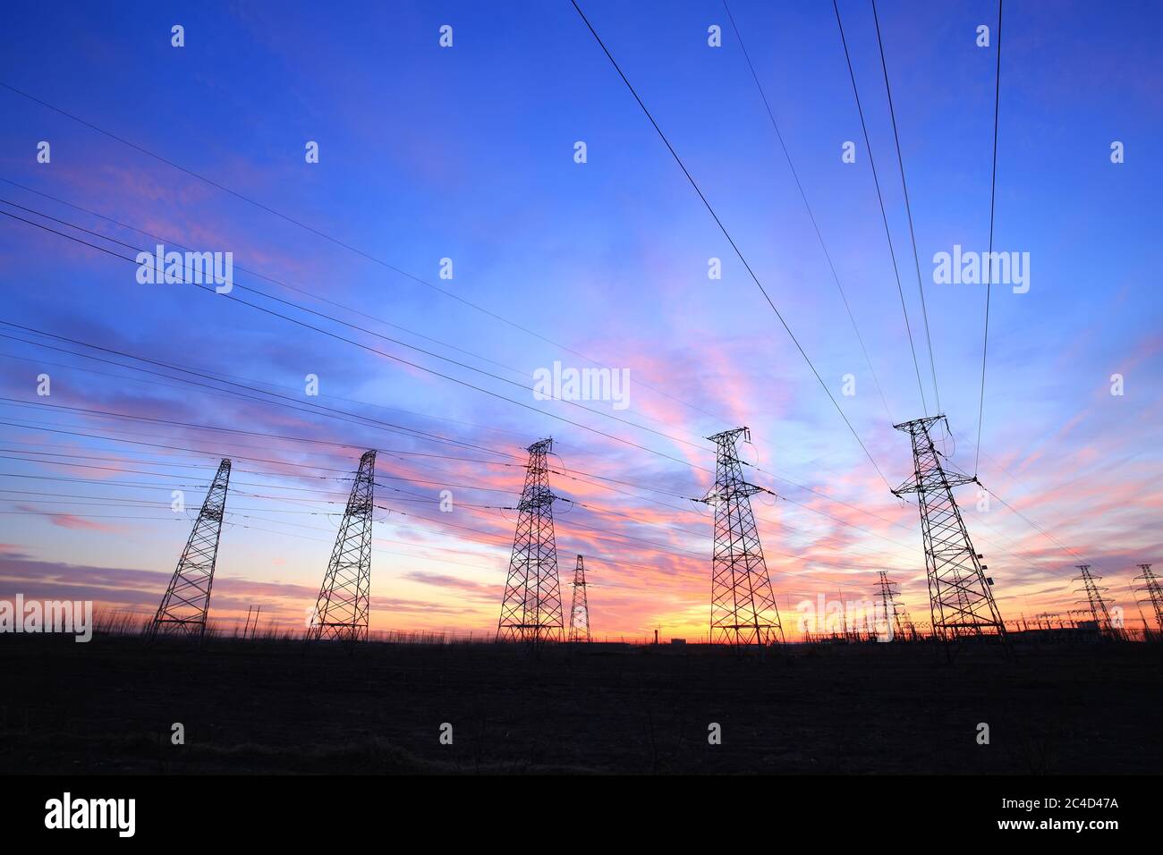 pylon, In the evening, the high voltage tower and the beautiful sunset glow Stock Photo