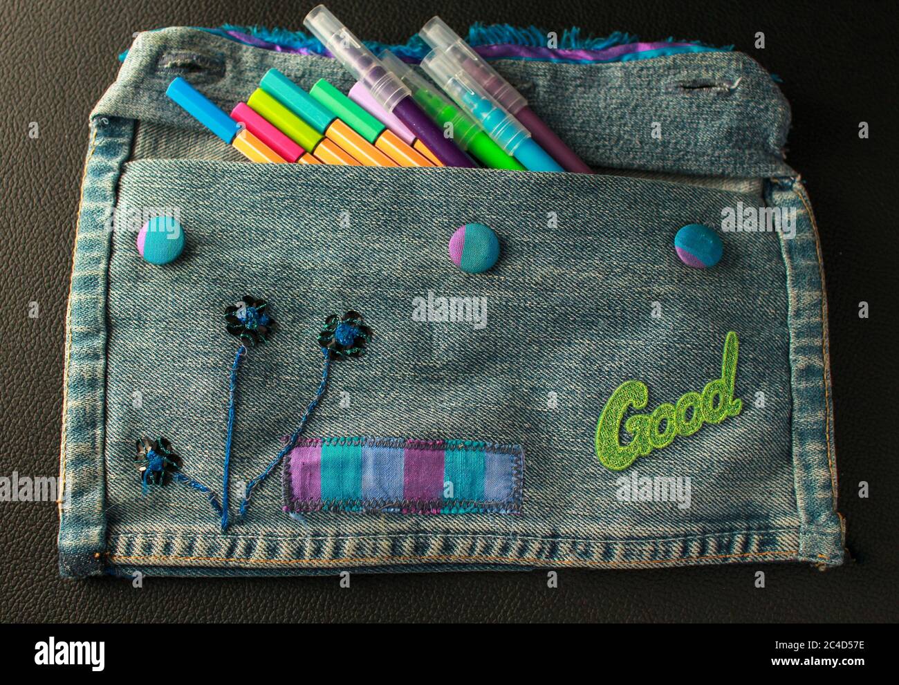 Closeup of DIY pencil case made of jeans and other objects with colorful  pens in it Stock Photo - Alamy