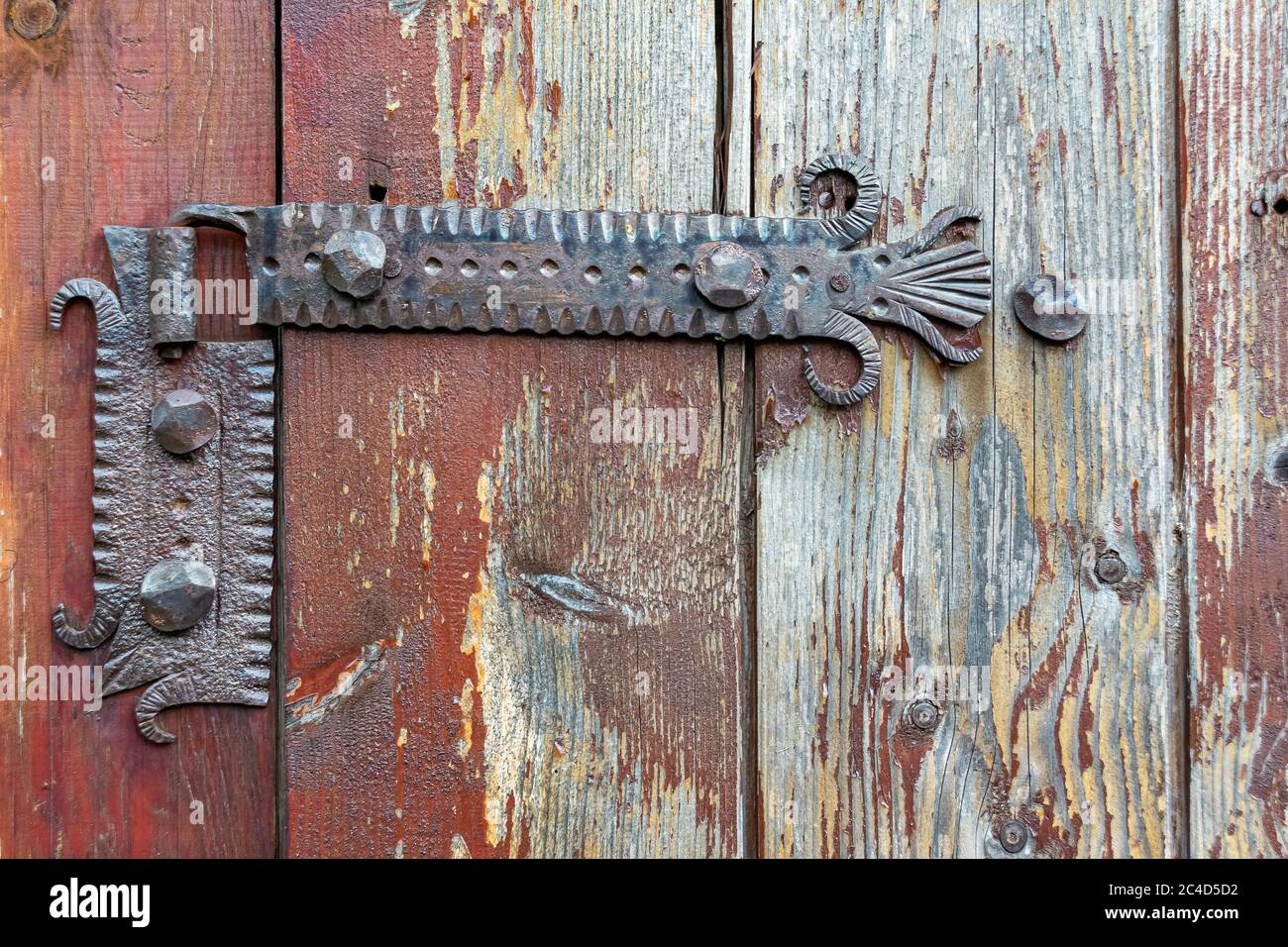 Old rusty door hinge on wooden planks, decoration detail Stock Photo