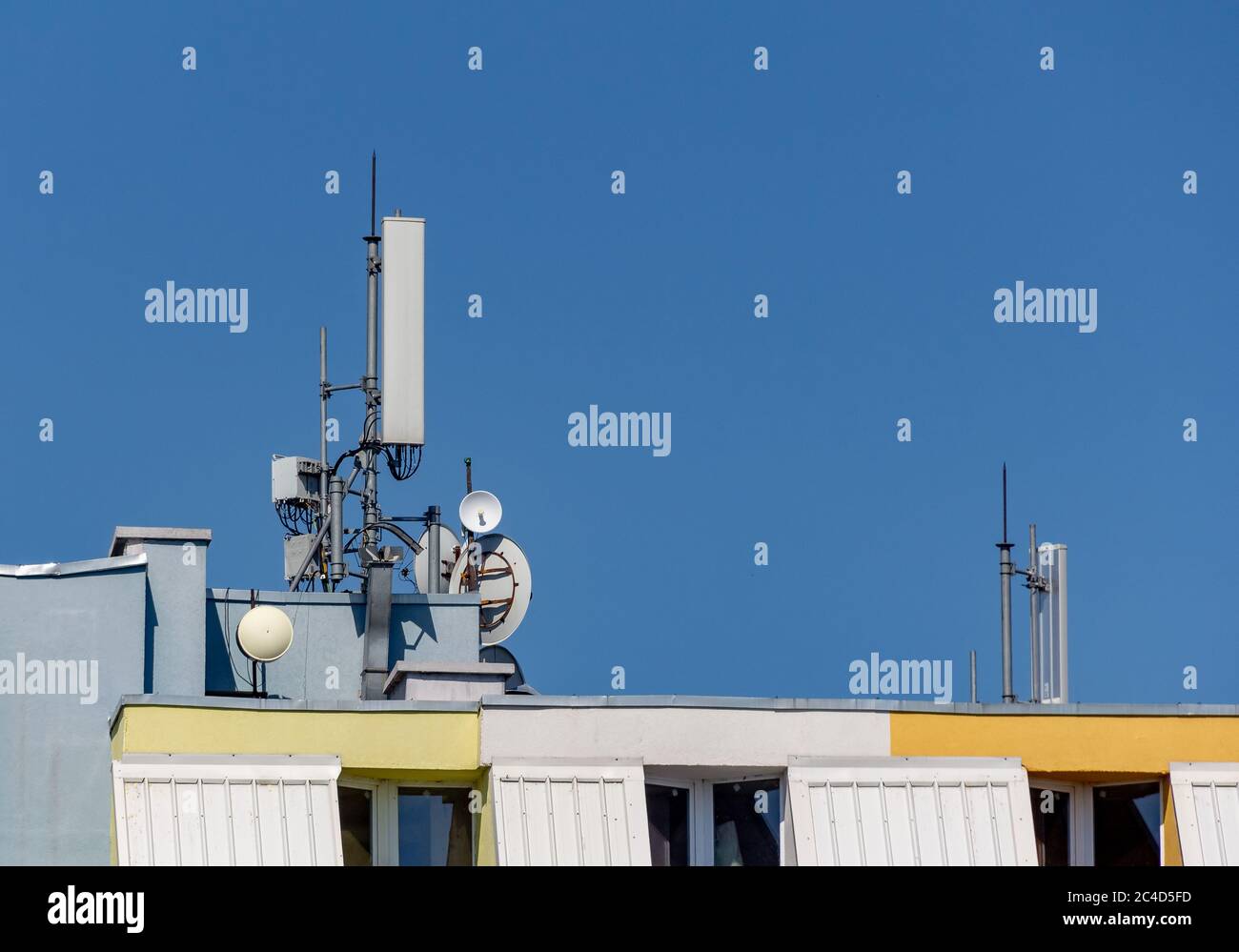 Cellular phone connection antennas on a residential building, 5G threat Stock Photo