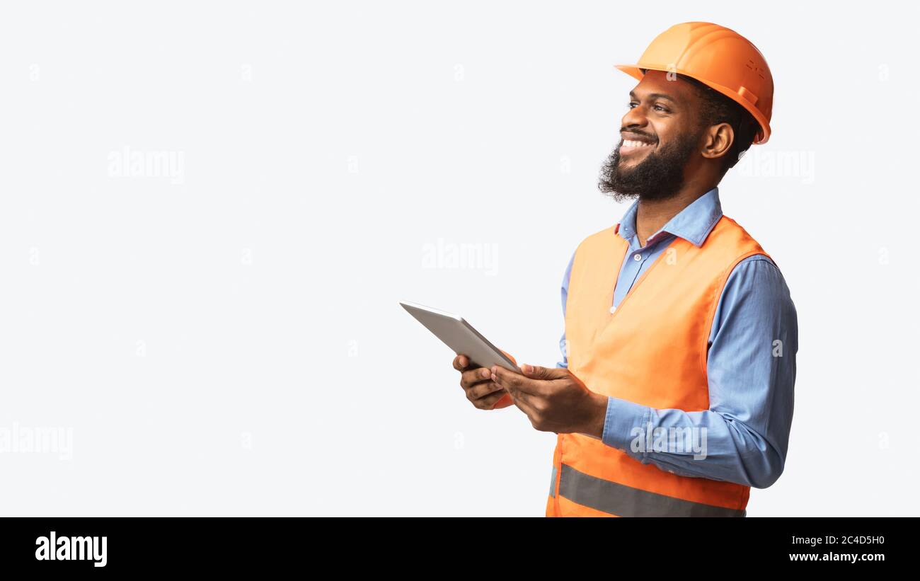 African Construction Foreman Worker Holding Tablet Computer Over White Background Stock Photo