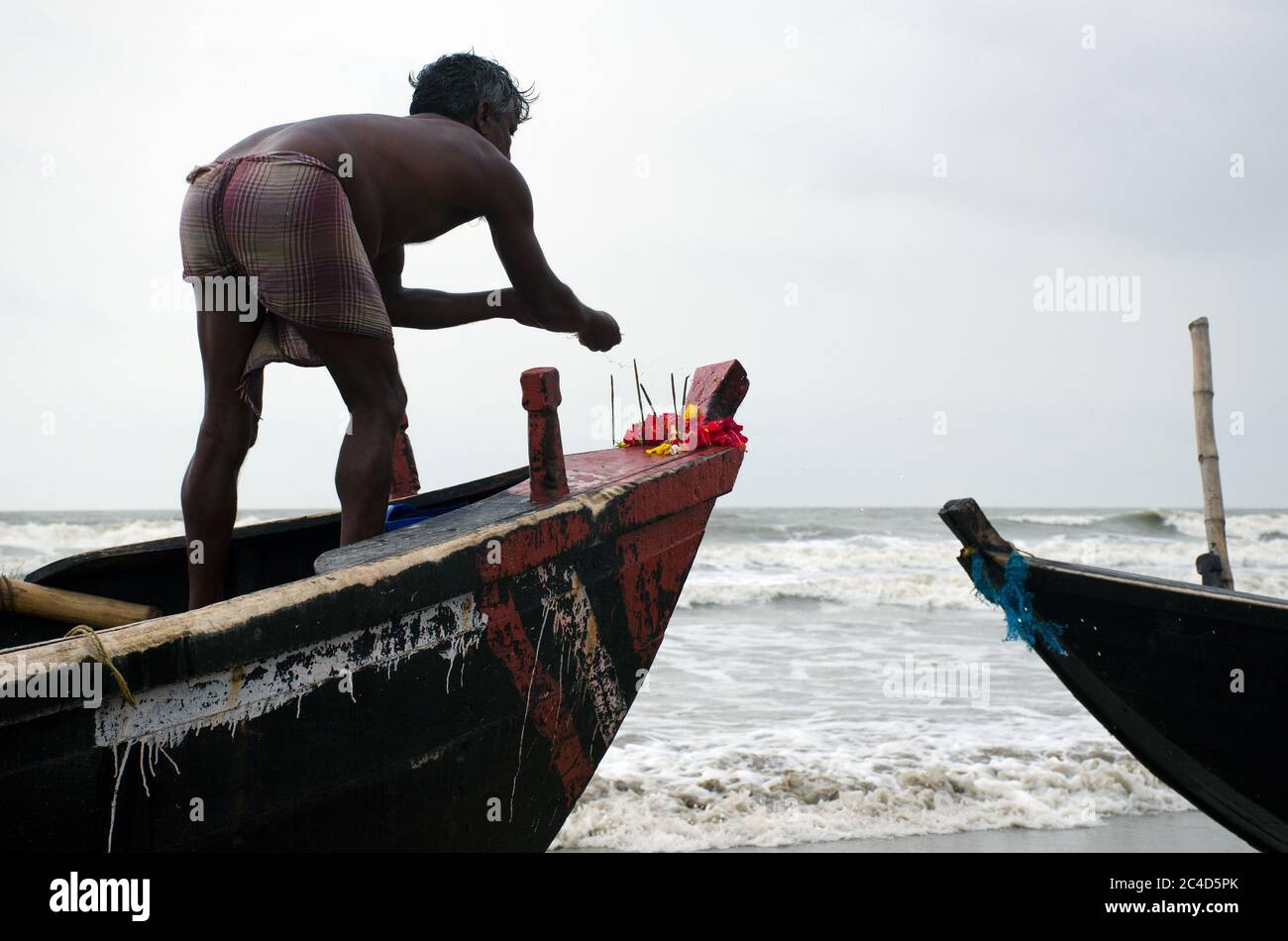 mandermoni sea beach west bengal india on may 29th 2018 : Worship of the fishing boat on Mandermoni beach. This is a fisherman's ritual before going f Stock Photo