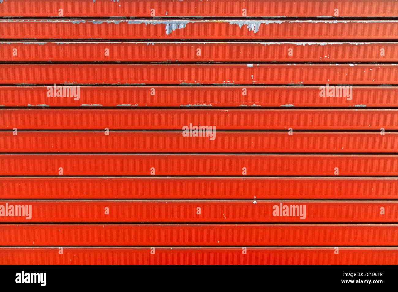 Orange metal shutter texture. Architectural detail, closeup. Material background. Paint peeling and ruined by time and bad weather. Stock Photo