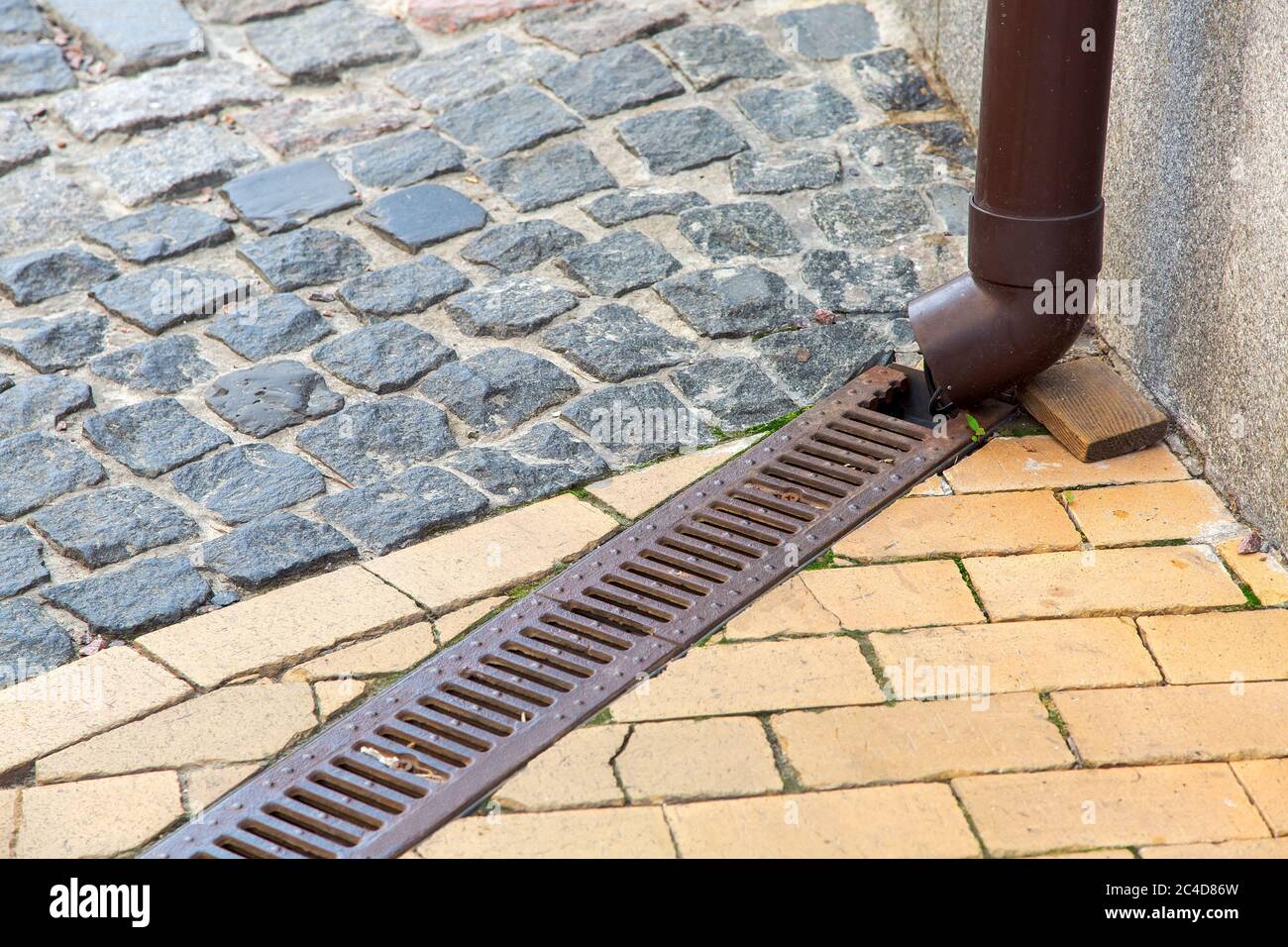 a rainwater drainage pipe system under a pedestrian pavement made of