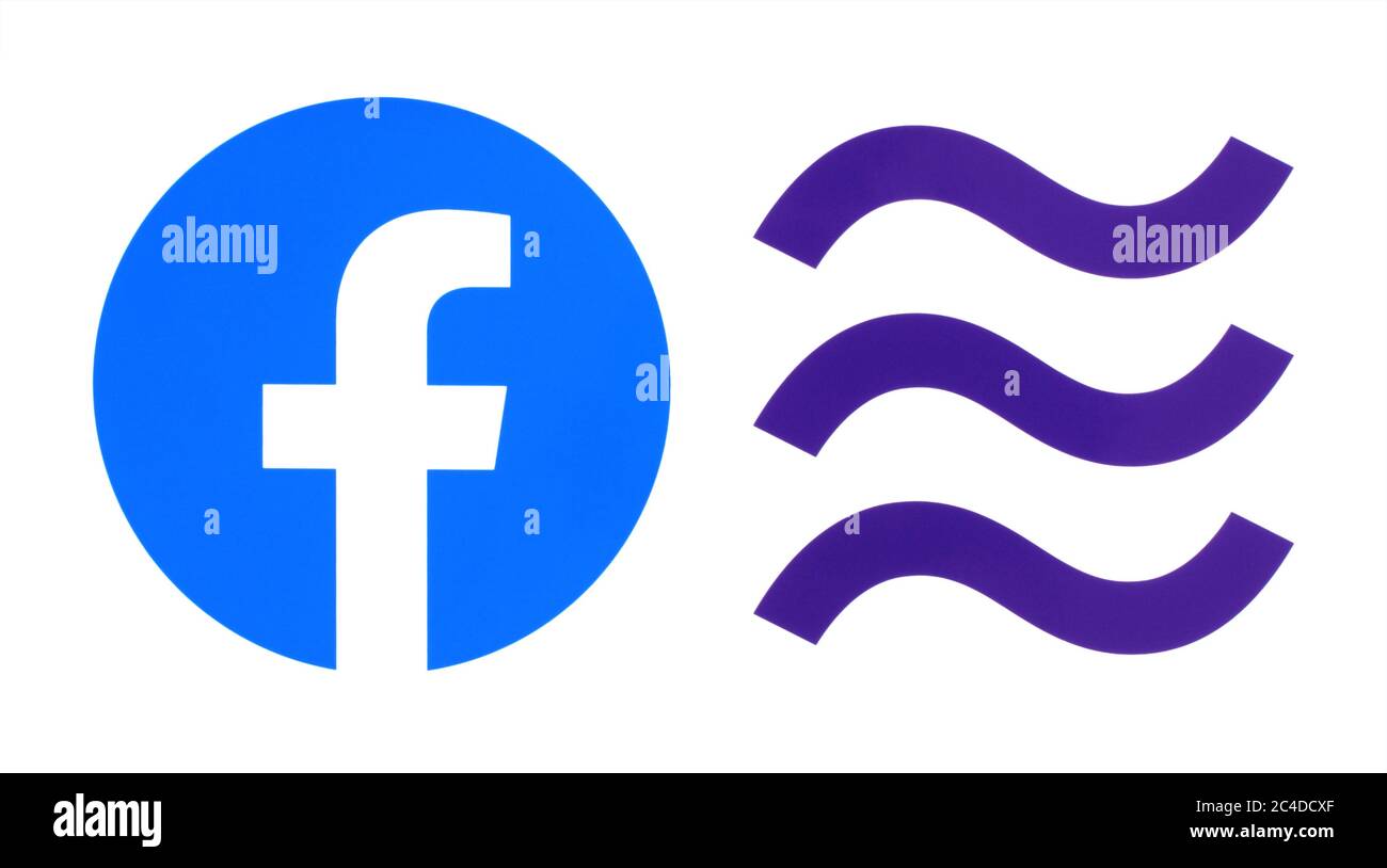 Kiev, Ukraine - October 29, 2019: New Facebook logo with Libra logo printed on paper. Libra is a proposed permissioned blockchain virtual currency by Stock Photo