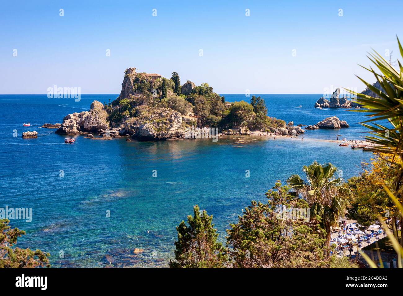 The Isola Bella island with the beach, excursion boats and bathers in Taormina, Italy Stock Photo