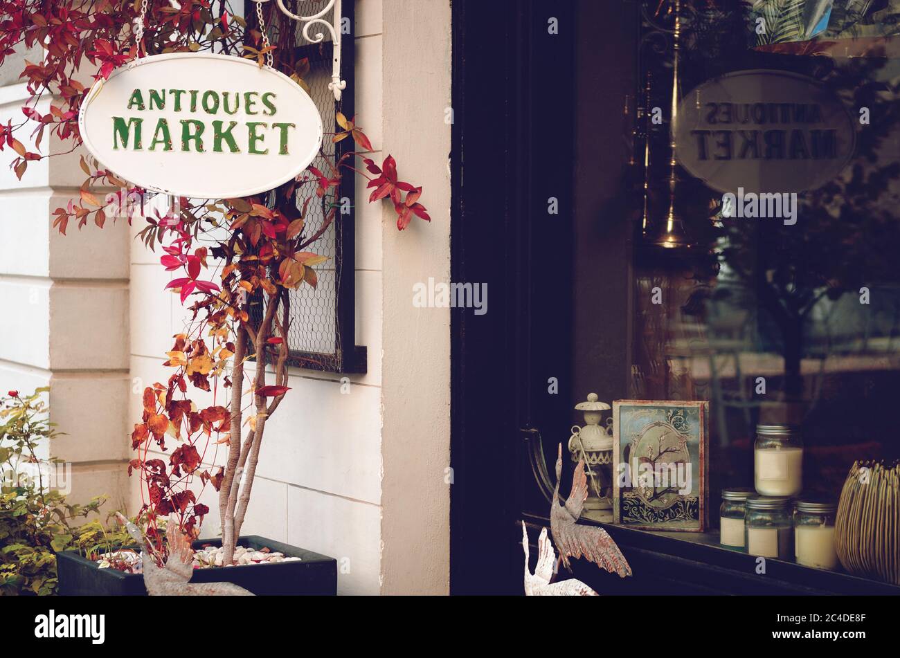 Antiques shop signboard adn front window in the streets of a quiet town