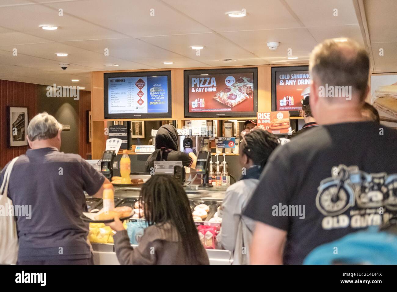 Customers seen queuing for refreshments in a popular, well-known, UK high street retailer. Stock Photo