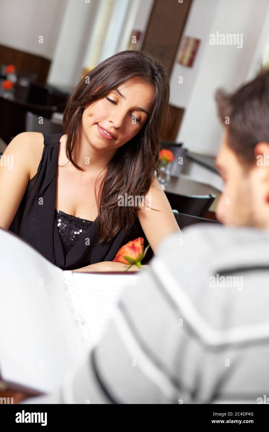 Young couple in the restaurant looks at the menu Stock Photo