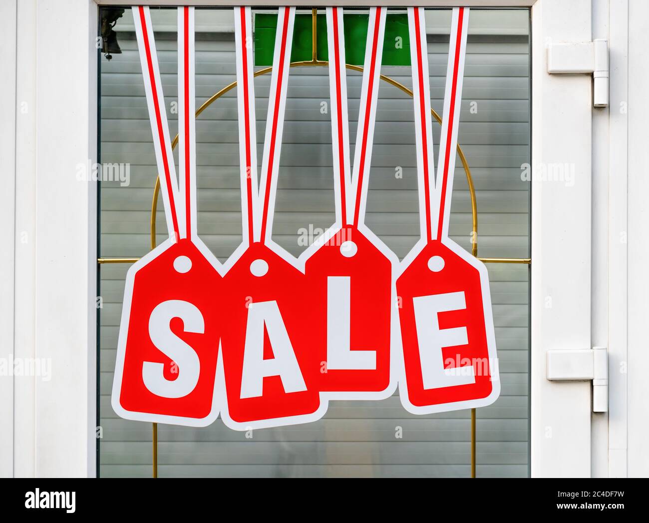 Red sale sign on the glass of door in shop. Business service and food concept. Vintage tone filter color style. Stock Photo