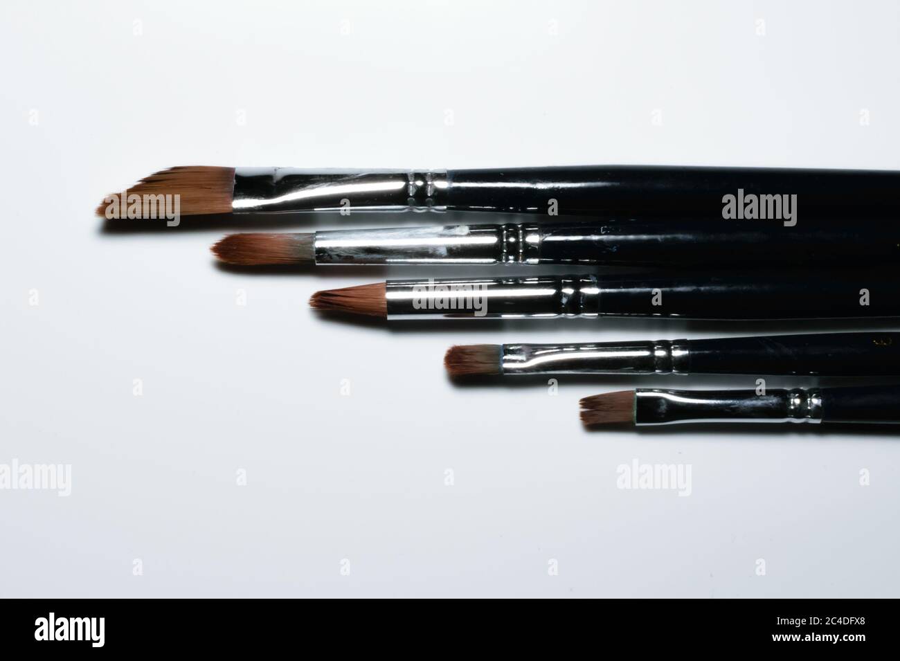 Painting brushes are kept side by side in descending order. White background Stock Photo