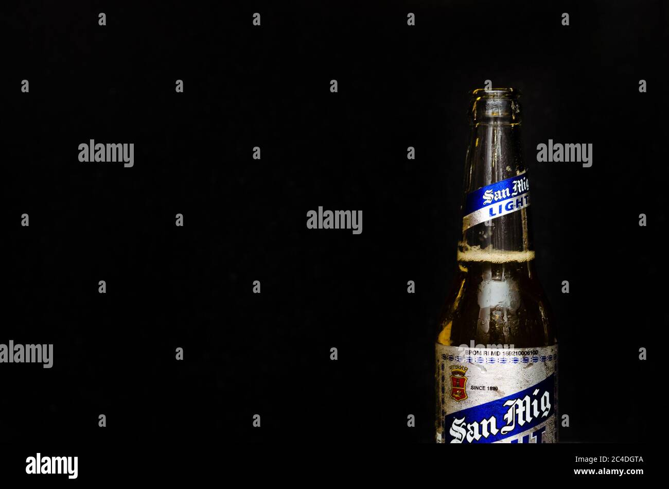 Close up view of San Miguel Light beer with silver and blue label in a black marble background Stock Photo