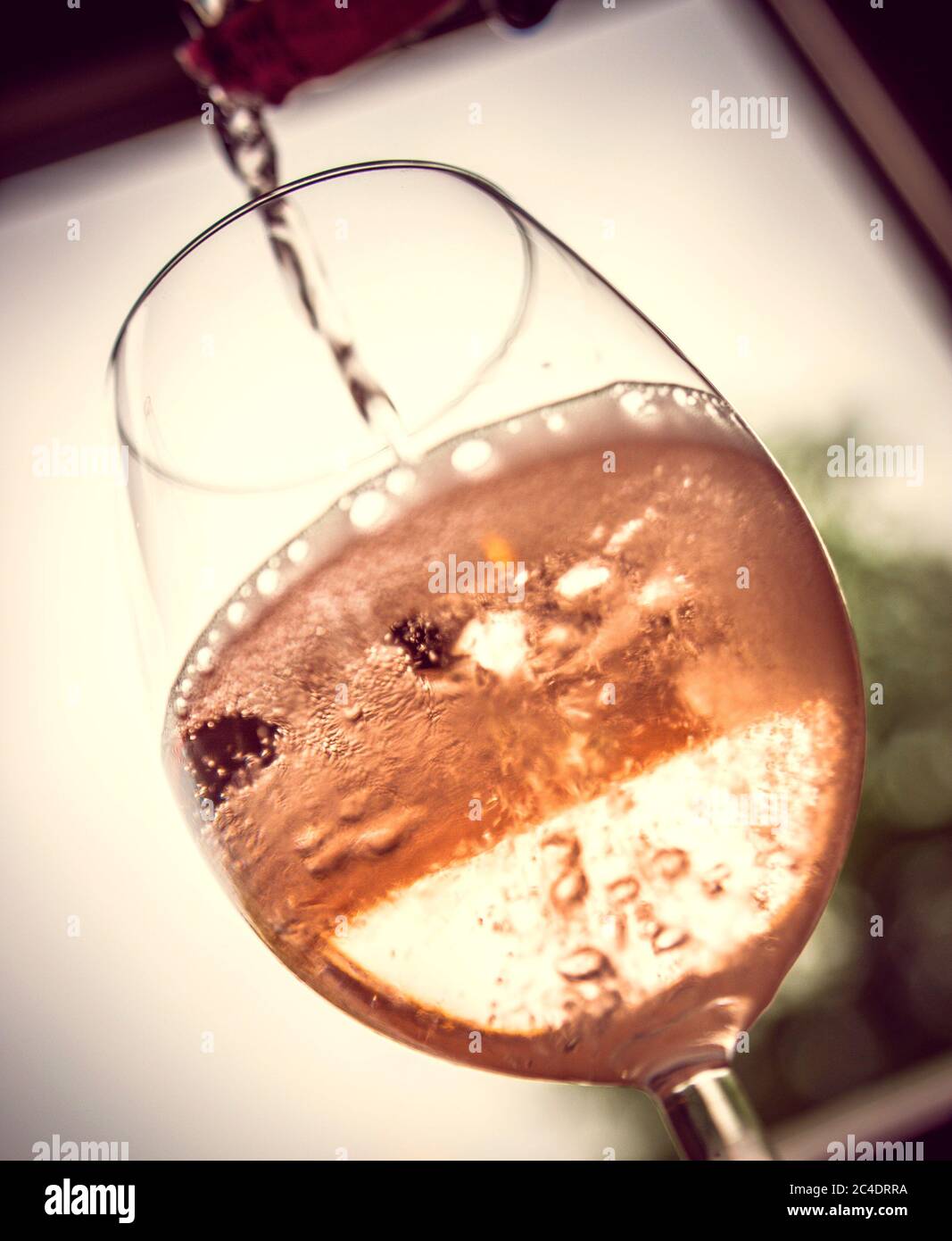 Pour Rosé into Wineglass Stock Photo