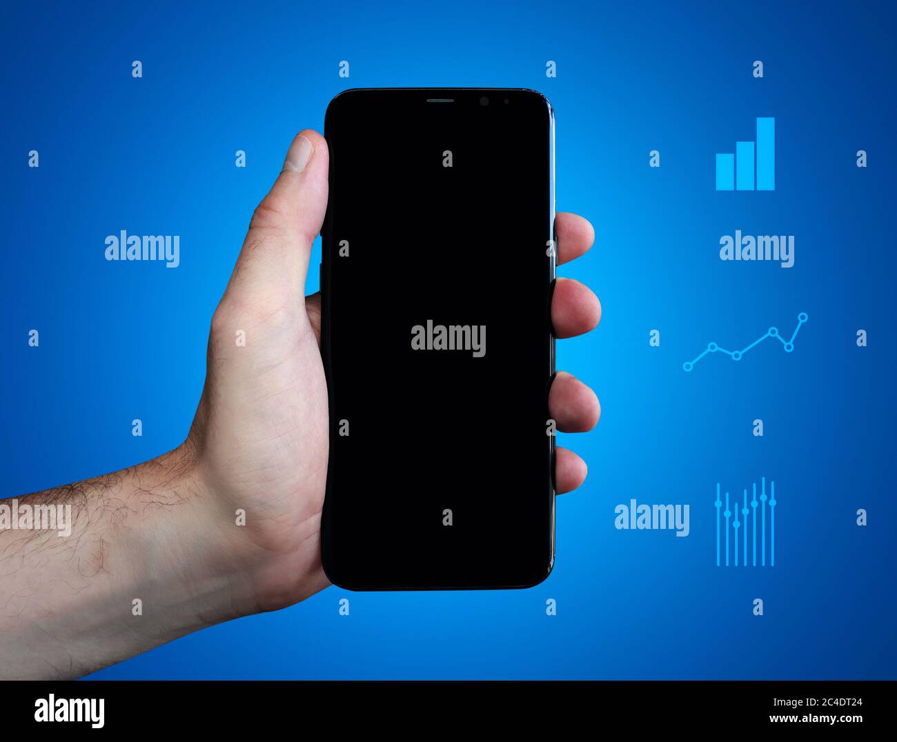 Hand holds cell phone and show Display. Charts on blue background. Business Stock Photo