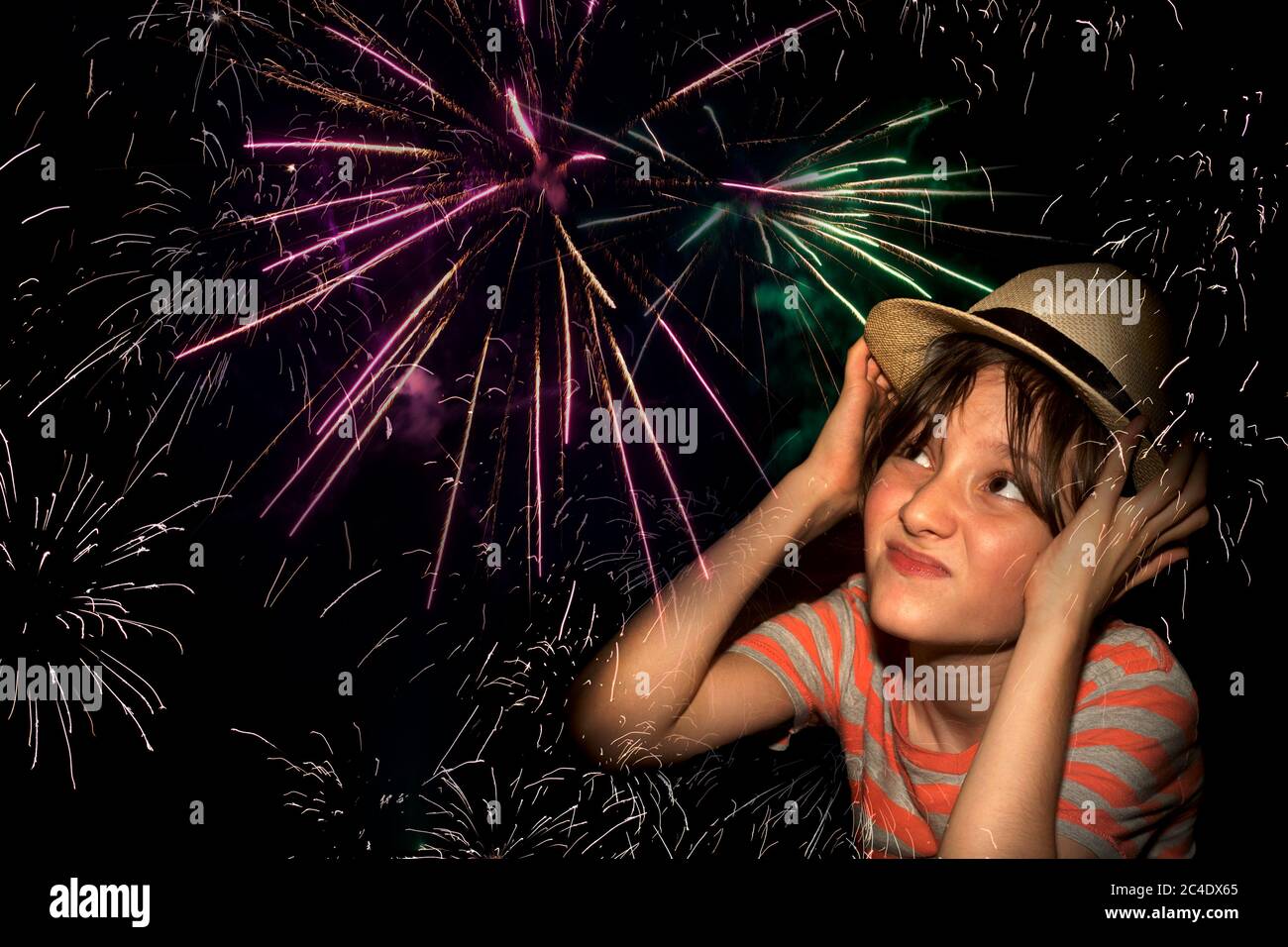 Boy covering his ears from the noise of fireworks Stock Photo Alamy