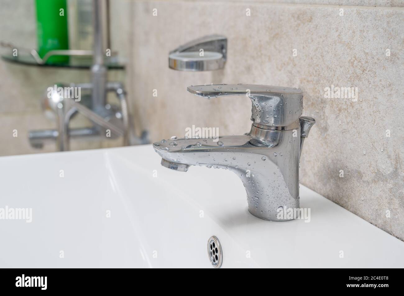 Disinfecting the bathroom. Faucet cleaning and disinfection. Prevention of coronavirus infection. Stock Photo