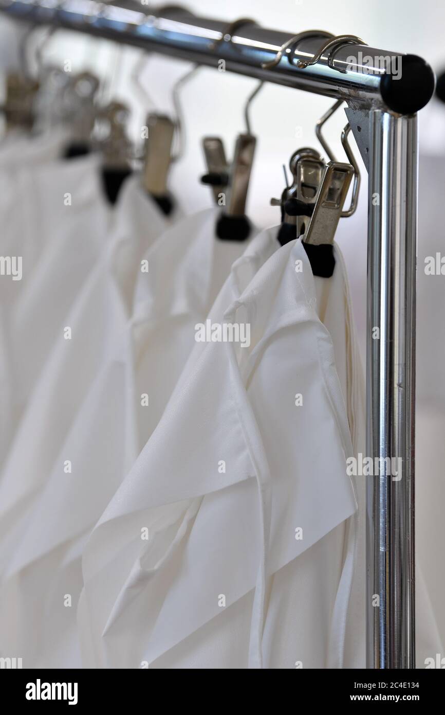 26 June 2020, Saxony, Schreiersgrün: Protective suits are hanging on a  clothes rail in the Seidel Moden ready-made clothing line. The Saxon  textile and clothing industry is promoting the fact that authorities
