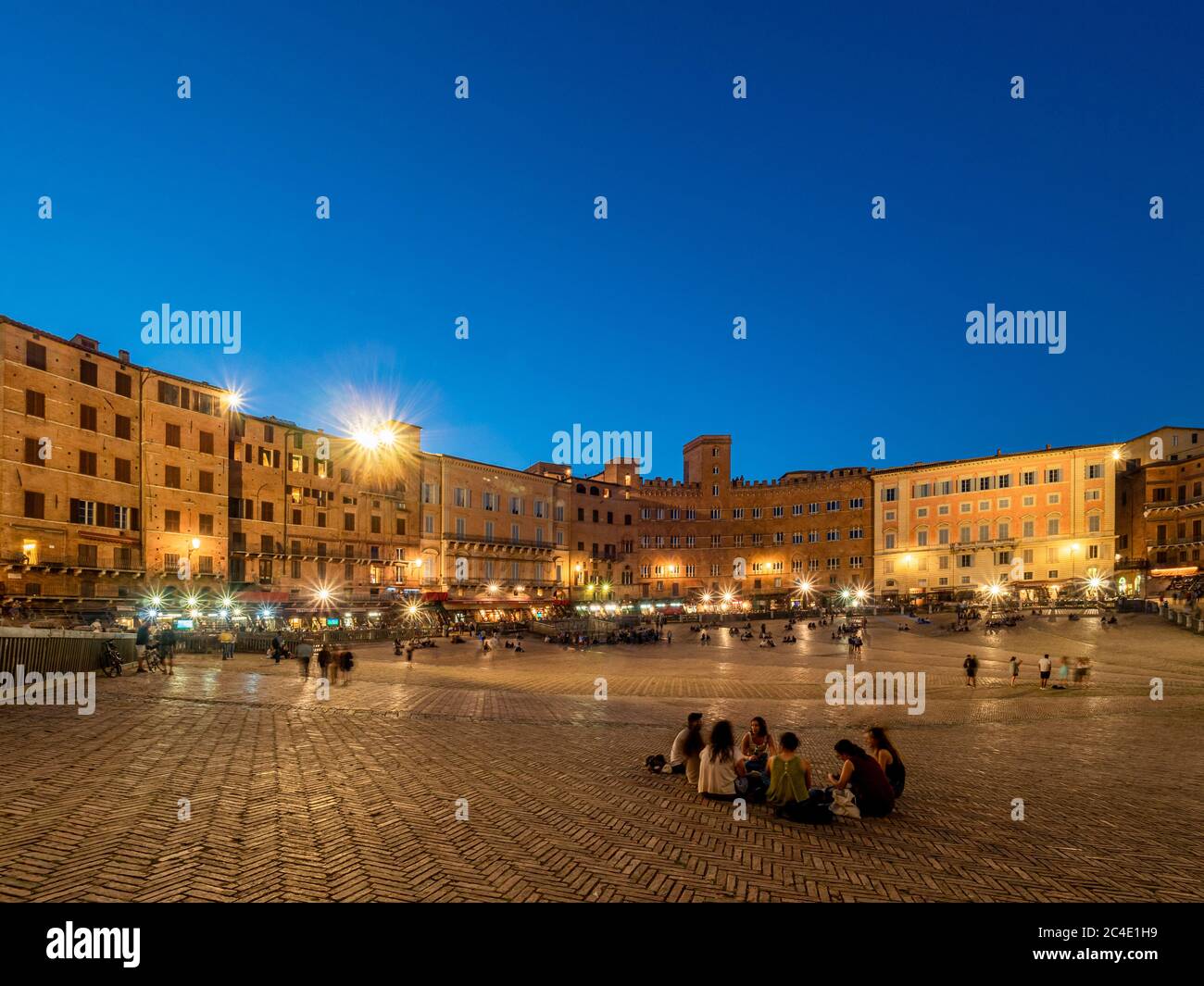 Night time shot of tourists in the Piazza del Campo, Siena. Italy. Stock Photo