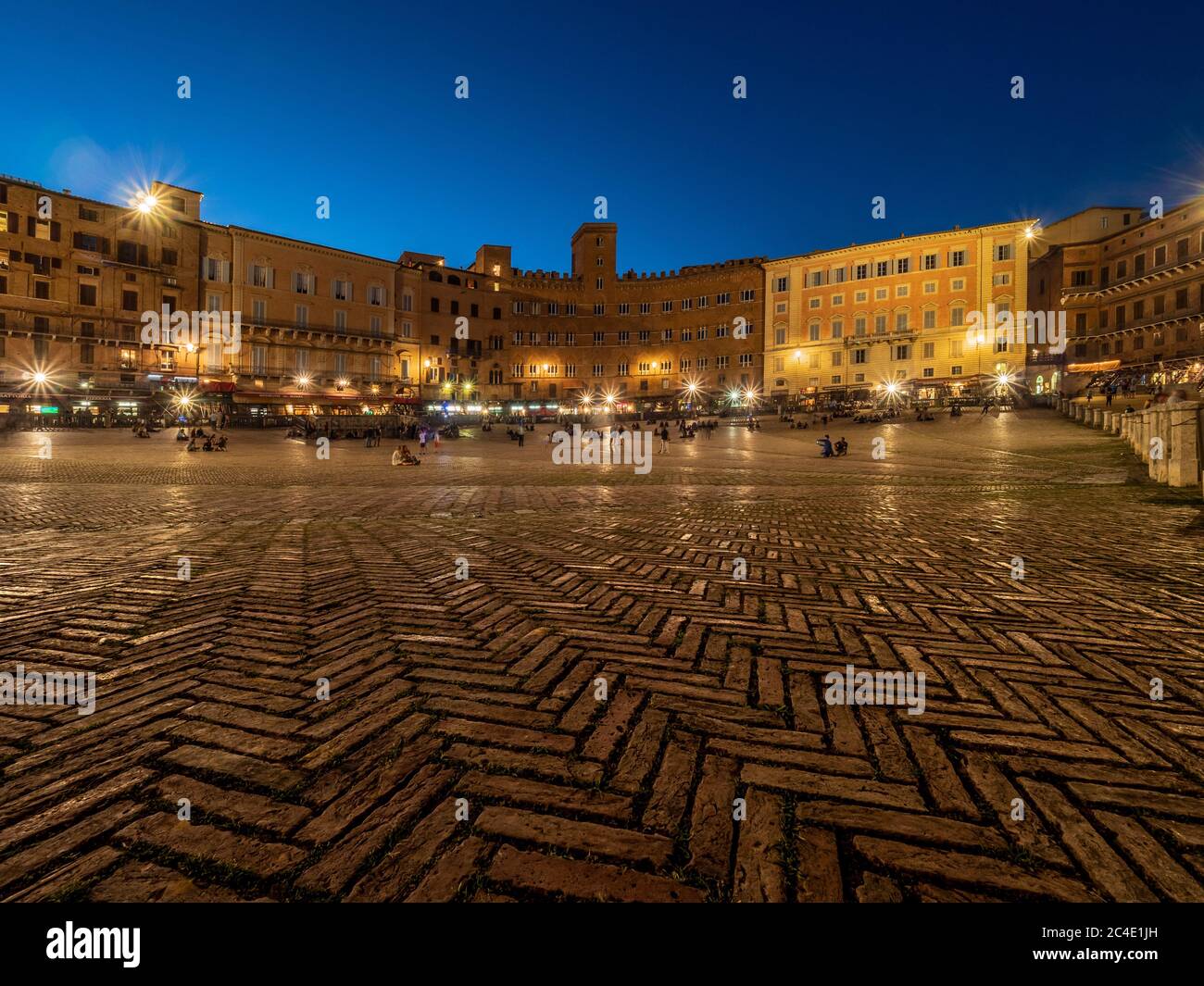 Night time shot of tourists in the Piazza del Campo, Siena. Italy. Stock Photo