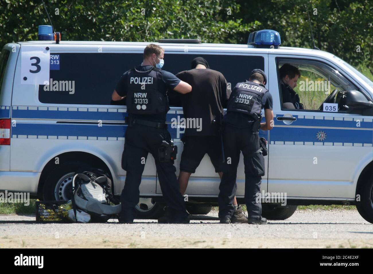 Jackerath, Germany. 26th June, 2020. An activist is searched by the police at the Garzweiler open-cast mine. Credit: David Young/dpa/Alamy Live News Stock Photo