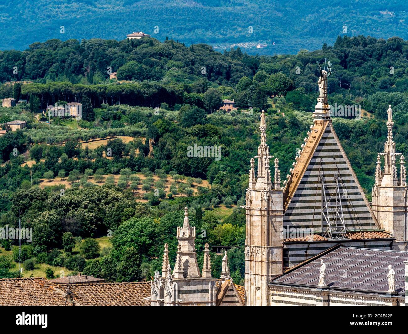 Rear view of the gable of the west front of Siena Cathedral looking out towards the Tuscan countryside. Siena, Italy. Stock Photo