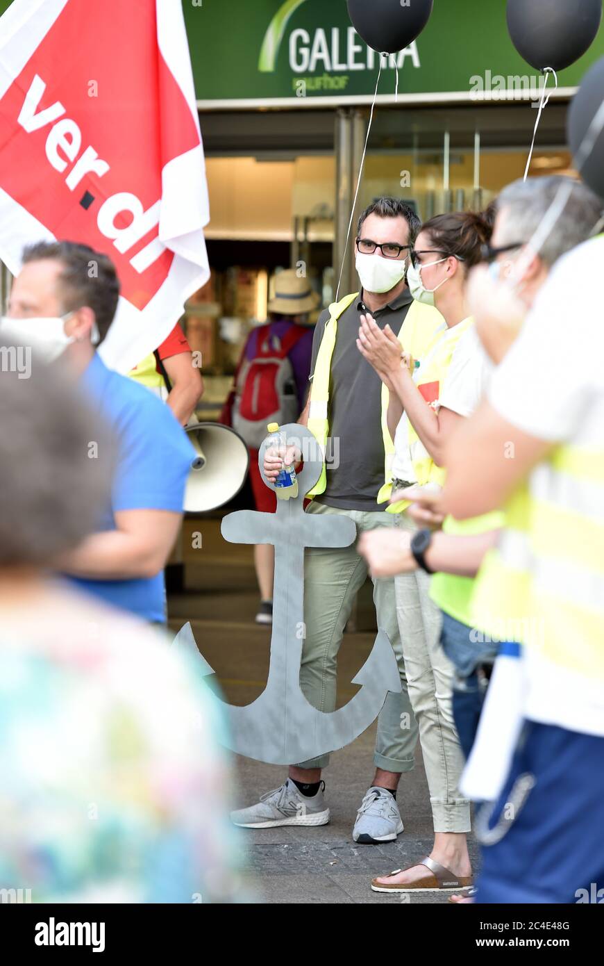 26 June 2020, North Rhine-Westphalia, Dortmund: Works councils, with a  cardboard anchor, from Galeria Karstadt Kaufhof and Karstadt Sports  demonstrate in front of one of the two stores in the city centre.