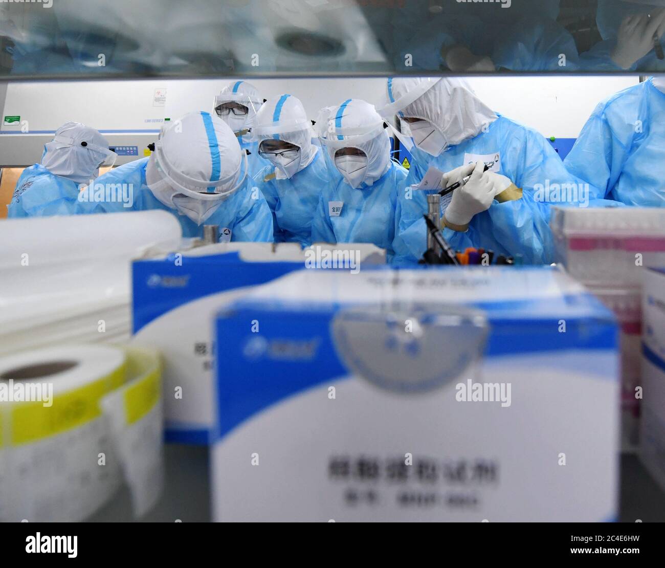 Beijing, China. 25th June, 2020. Staff members make preparations before processing samples for nucleic acid test at the laboratory of KingMed Diagnostics, a Chinese medical diagnostic testing company in Beijing, capital of China, June 25, 2020. With 2,422 sample collection points set up at 480 venues across the capital, Beijing can now offer more than 300,000 nucleic acid tests for COVID-19 every day. Credit: Zhang Chenlin/Xinhua/Alamy Live News Stock Photo