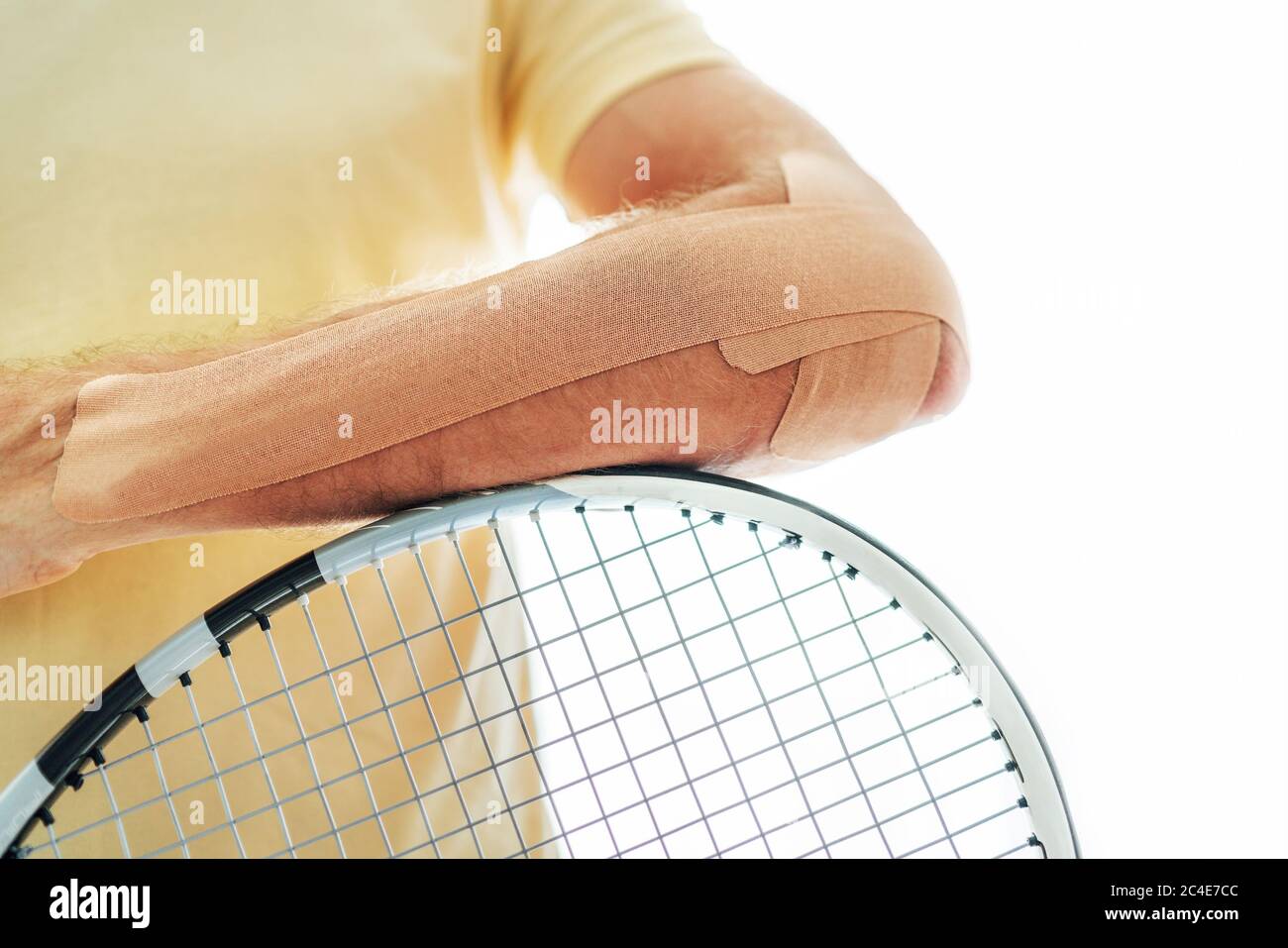 Tennis player elbow taped with elastic therapeutic or Kinesio tape