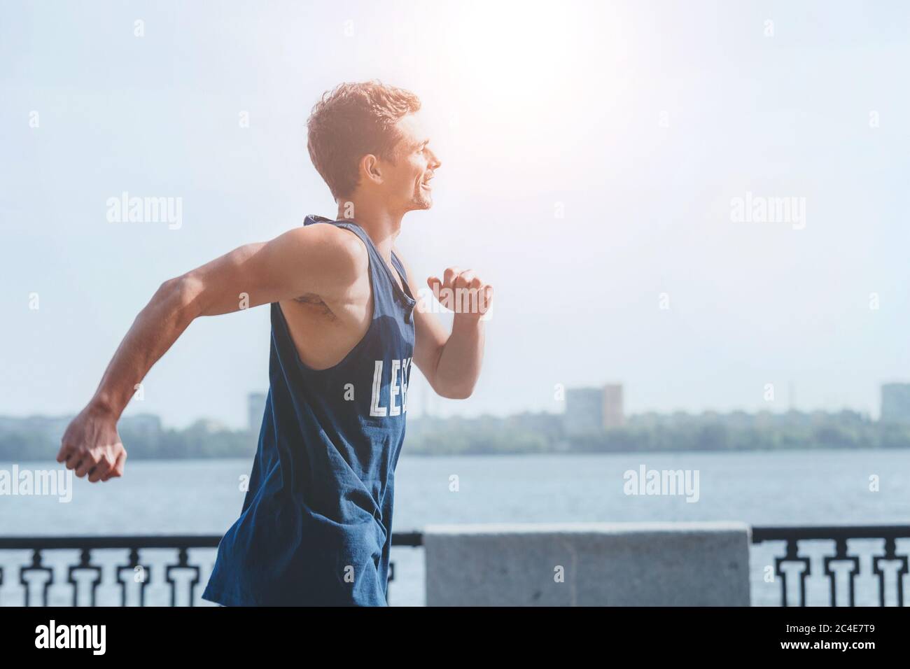 Active athlete muscular young man dressed sleeveless shirt running by ...