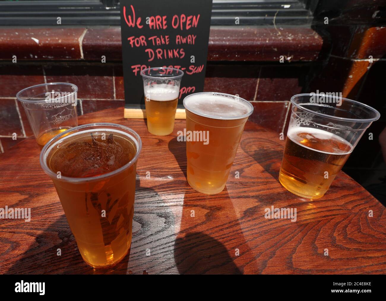 Takeaway pints of beer outside Charrington's Noted Ales And Stout pub in London, as further coronavirus lockdown restrictions are lifted in England. Stock Photo