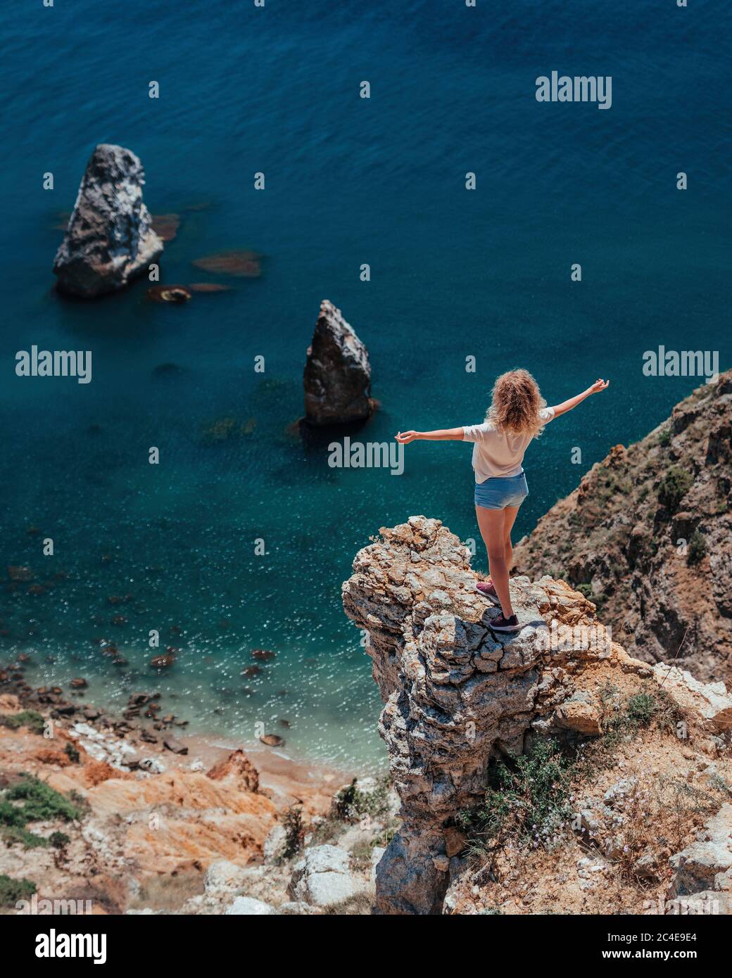 Girl standing on the cliff hi-res stock photography and images - Alamy