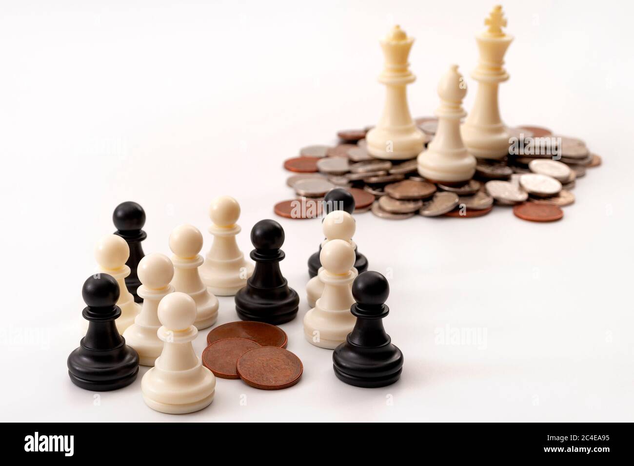 Income inequality and social issue concept theme with large group of chess pawns representing the poor and the middle class splitting a significantly Stock Photo