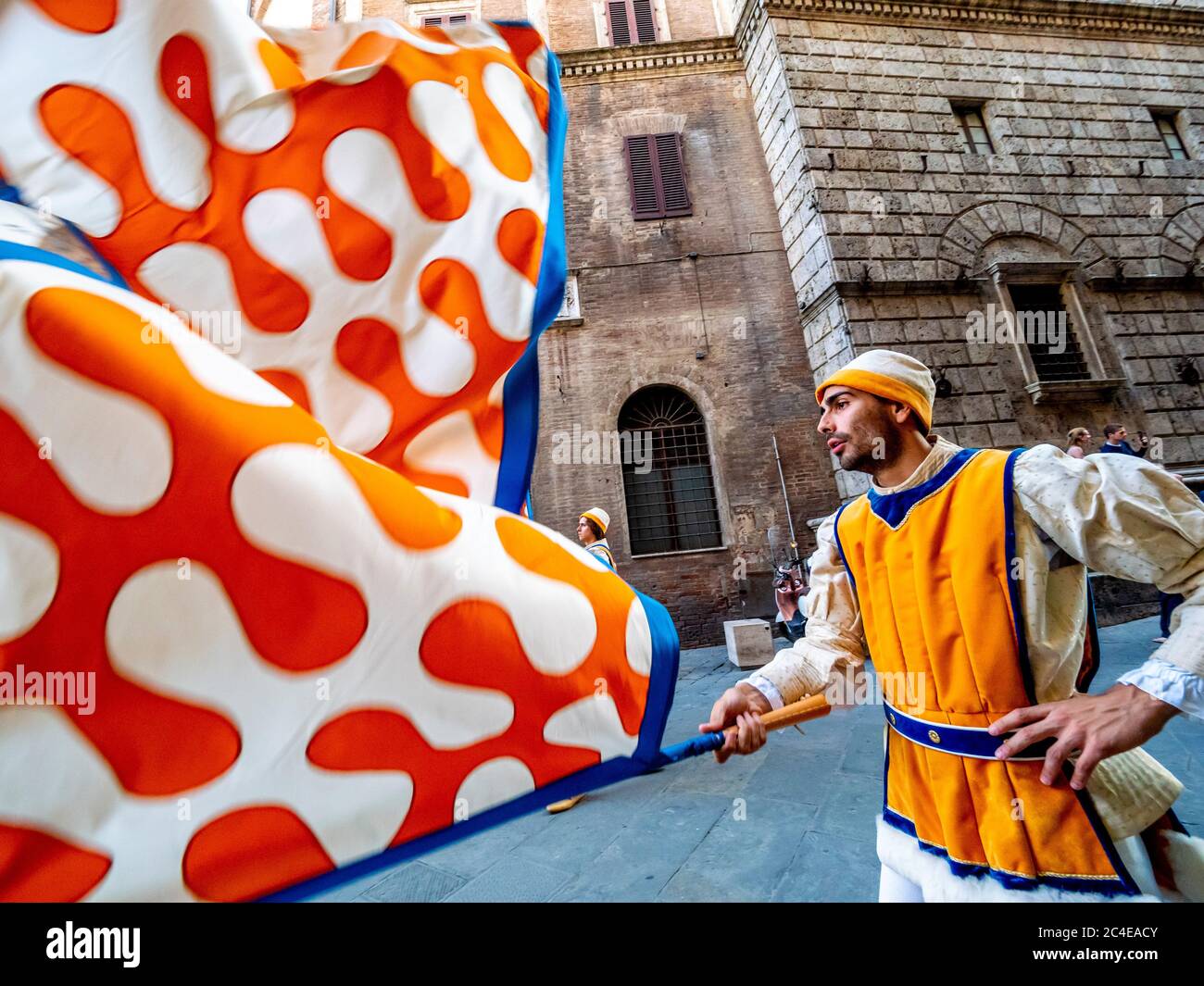 A contrada from the Leocorno district of Siena taking part in the  Corteo Storico, ahead of the twice yearly Palio. Stock Photo
