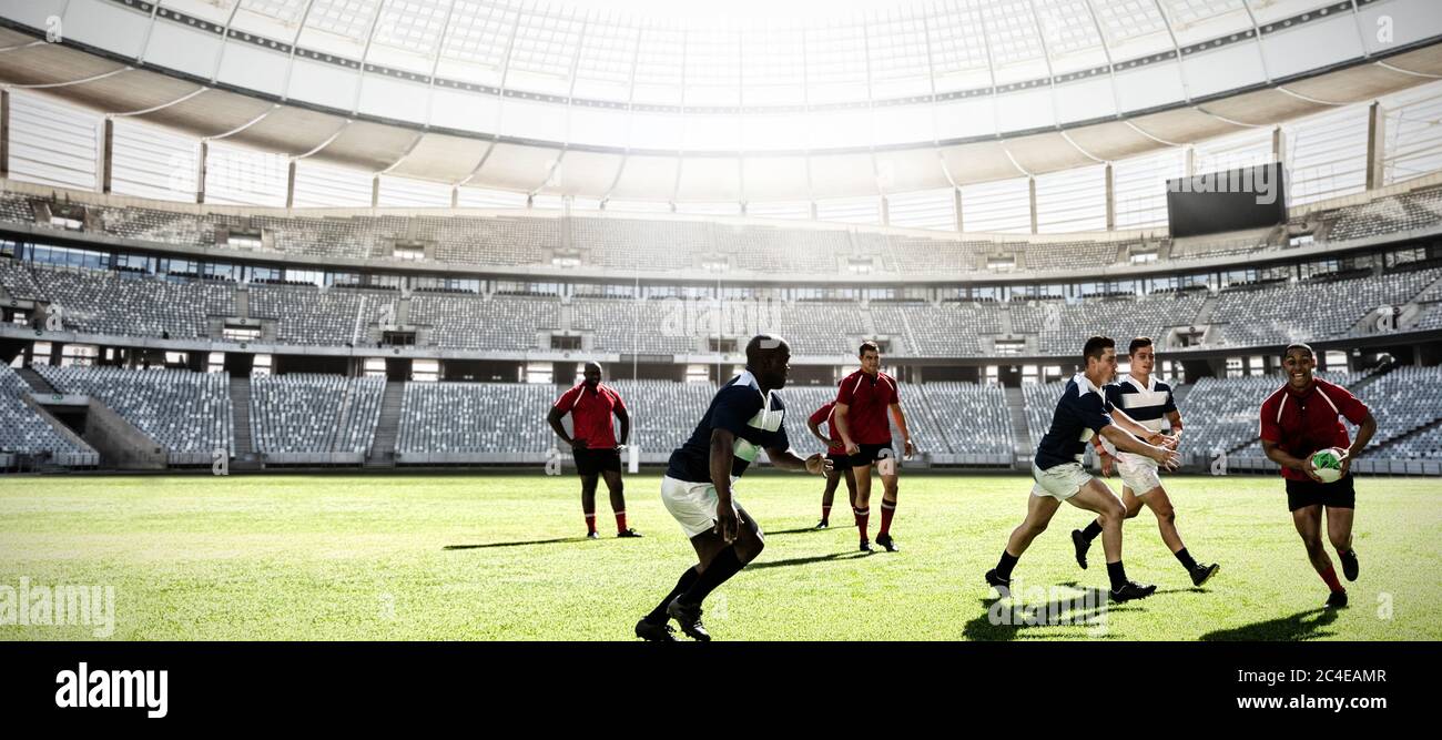 Digital composite image of team of rugby players playing rugby in sports stadium Stock Photo