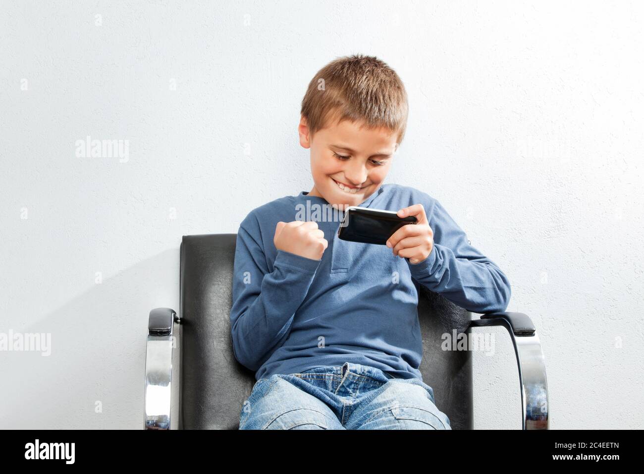 Child wins in mobile game on a smartphone Stock Photo