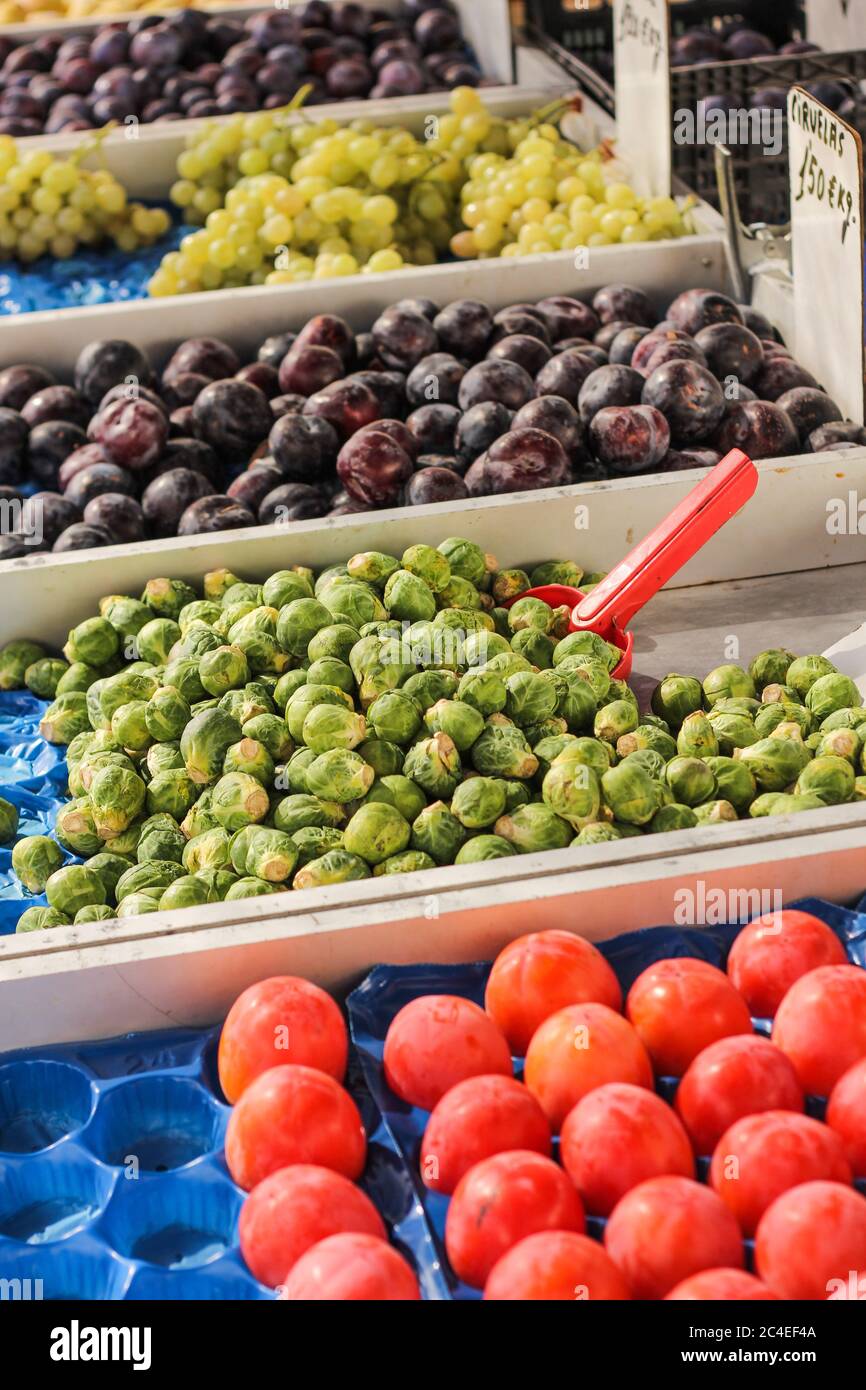 Vertical selective focus shot of fresh fruits in the boxes in the ...