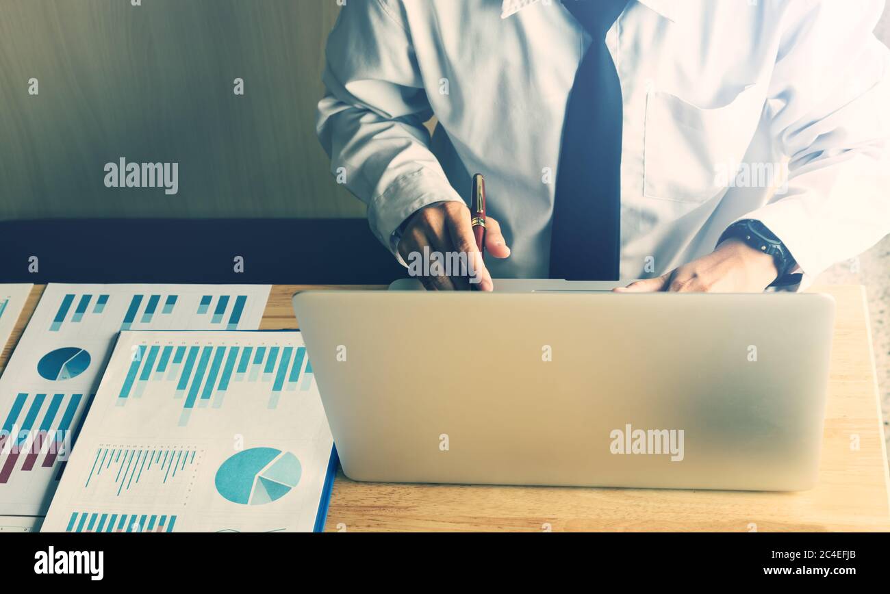 Businessman working in office room and using laptop computer. Stock Photo