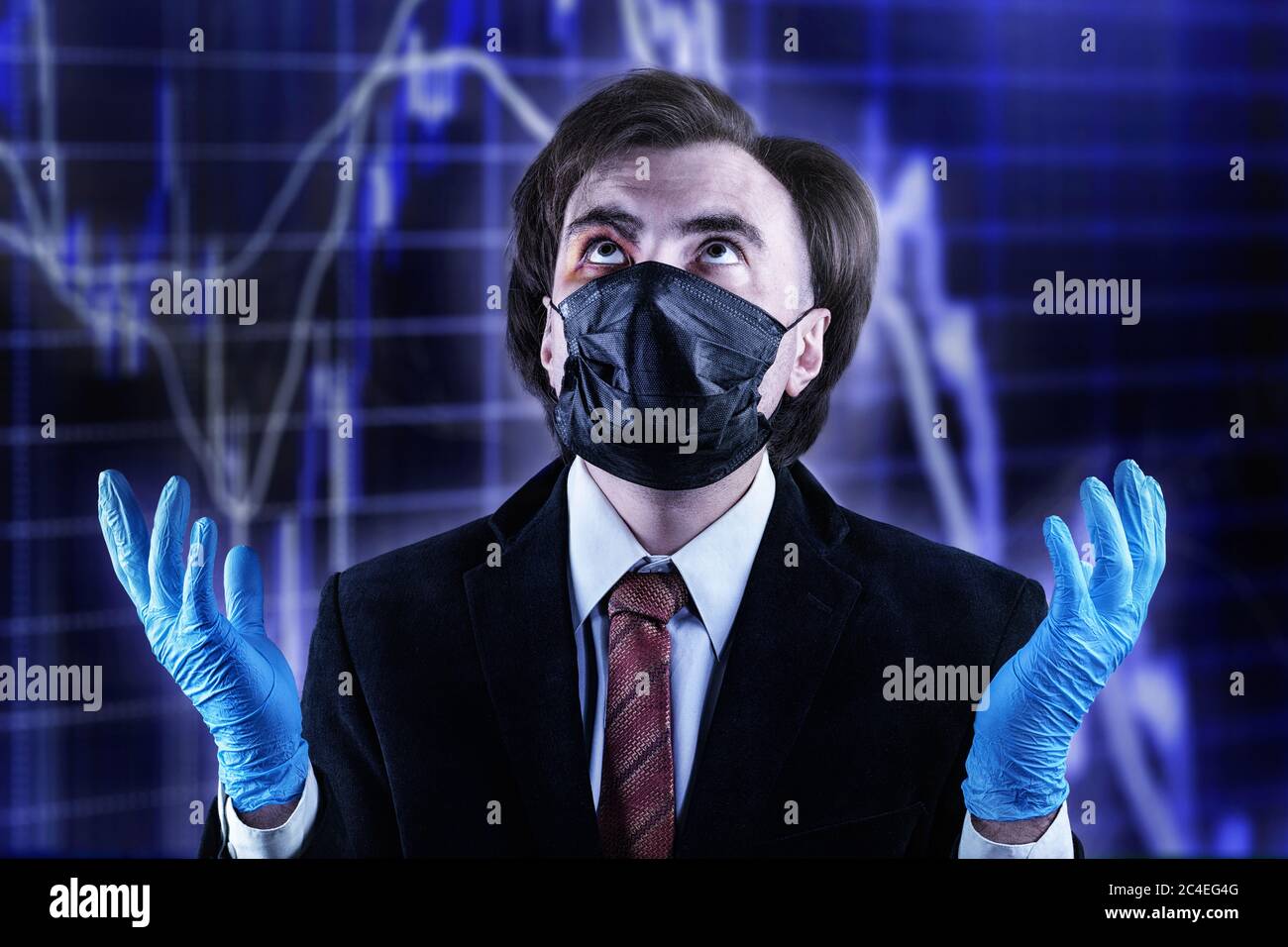 Businessman with a bruise on his face in an official suit, medical mask and gloves, raising his eyes to heaven against the blurred stock chart. Crisis Stock Photo