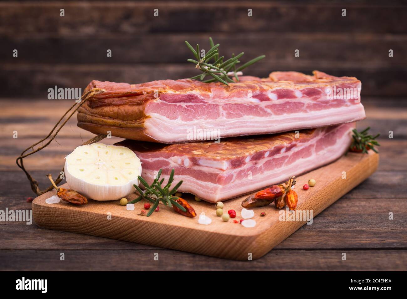Homemade smoked bacon on wooden board Stock Photo