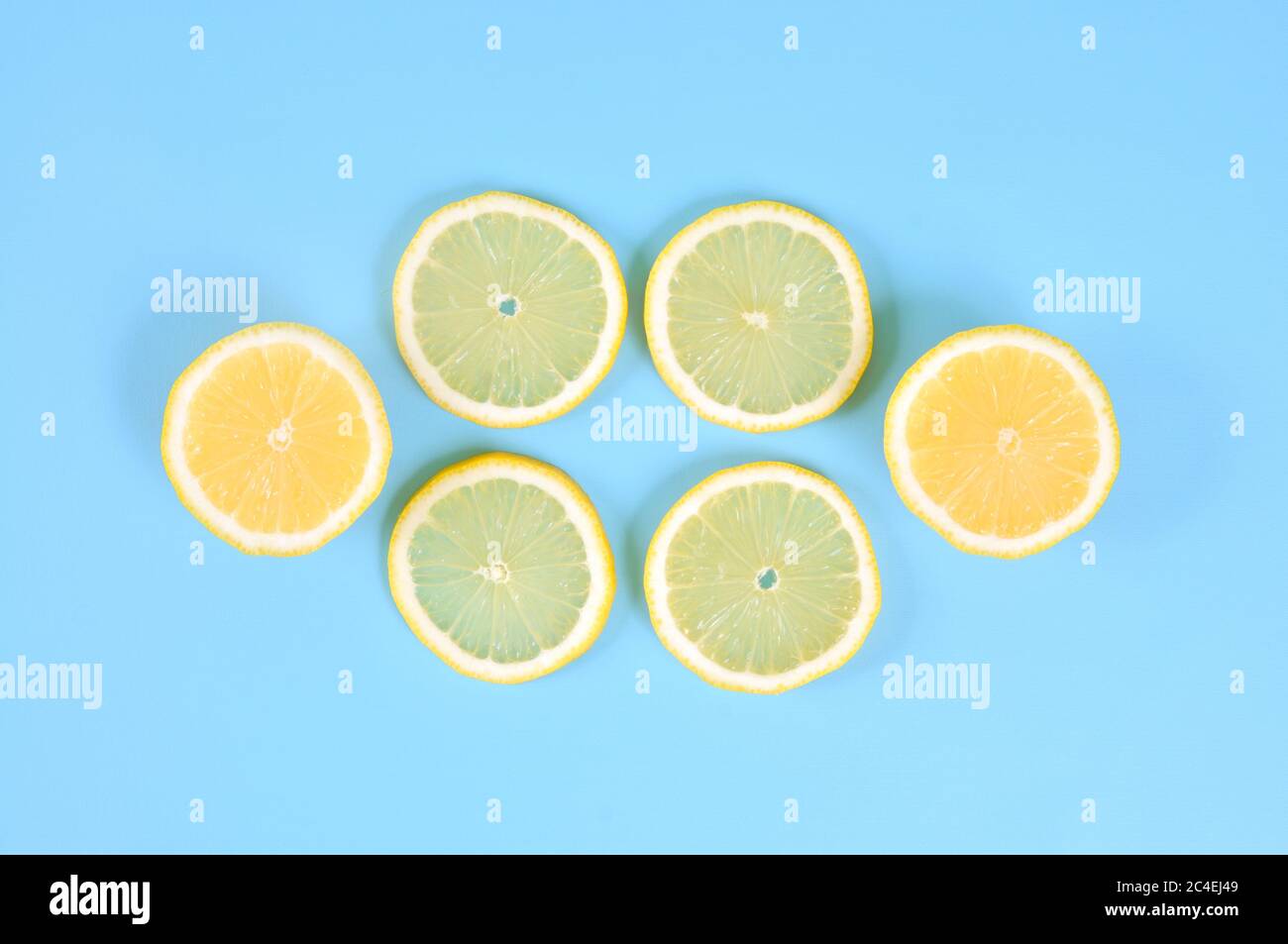 Lemon slices on blue background, top view Stock Photo