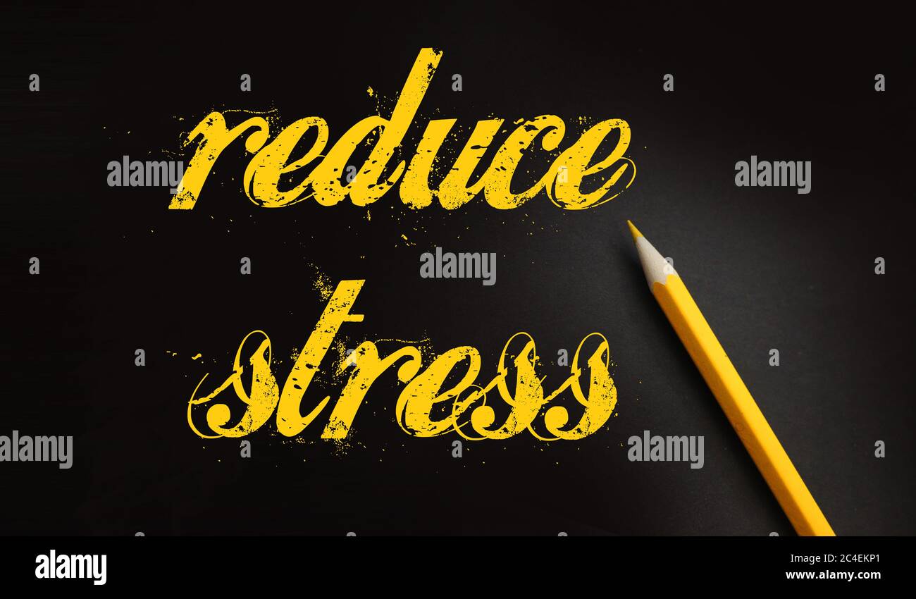 Reduce Stress text written yelllow on black with pencil. Stressfull life crisis management healthcare concept Stock Photo