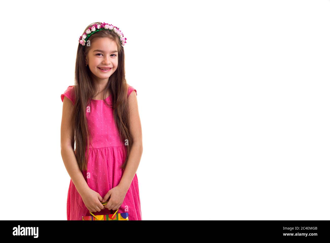 Cute little girl in pink dress at white background Stock Photo - Alamy