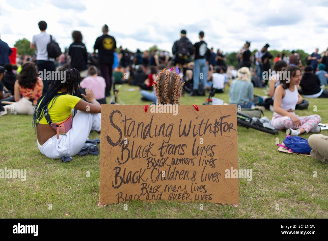 Protesters sit on the grass during a Black Lives Matter demonstration, Hyde Park, London, 20 June 2020 Stock Photo