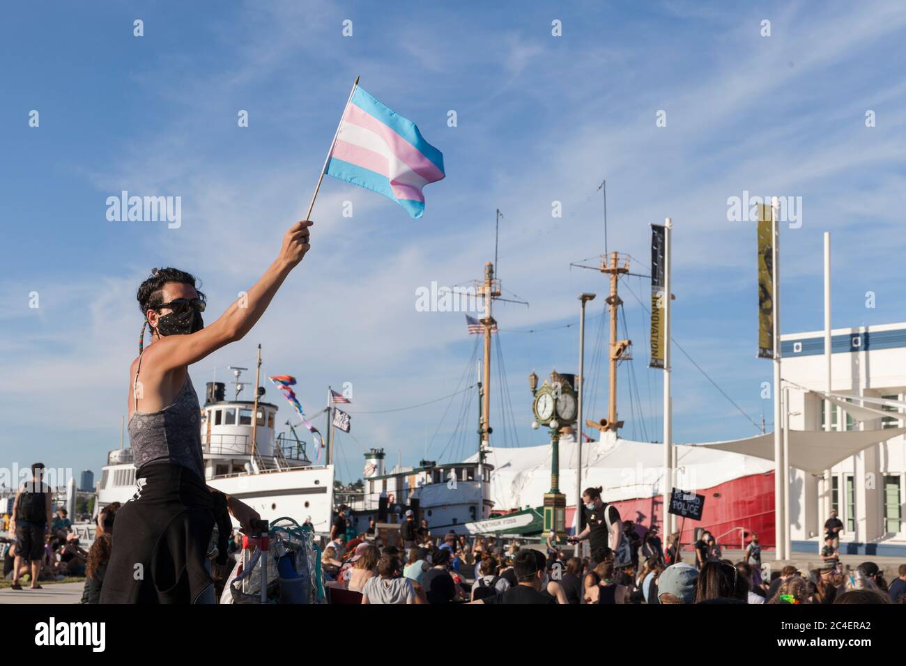 A supporter waves a transgender pride flag at the Museum of History & Industry during the All Black Lives Matter March, on South Lake Union in Seattle on Thursday, June 25, 2020. The march was held in support of the Black LGBTQ+ community and in solidarity for the murders of Riah Milton and Dominique Rem’mie and other black trans women. Stock Photo
