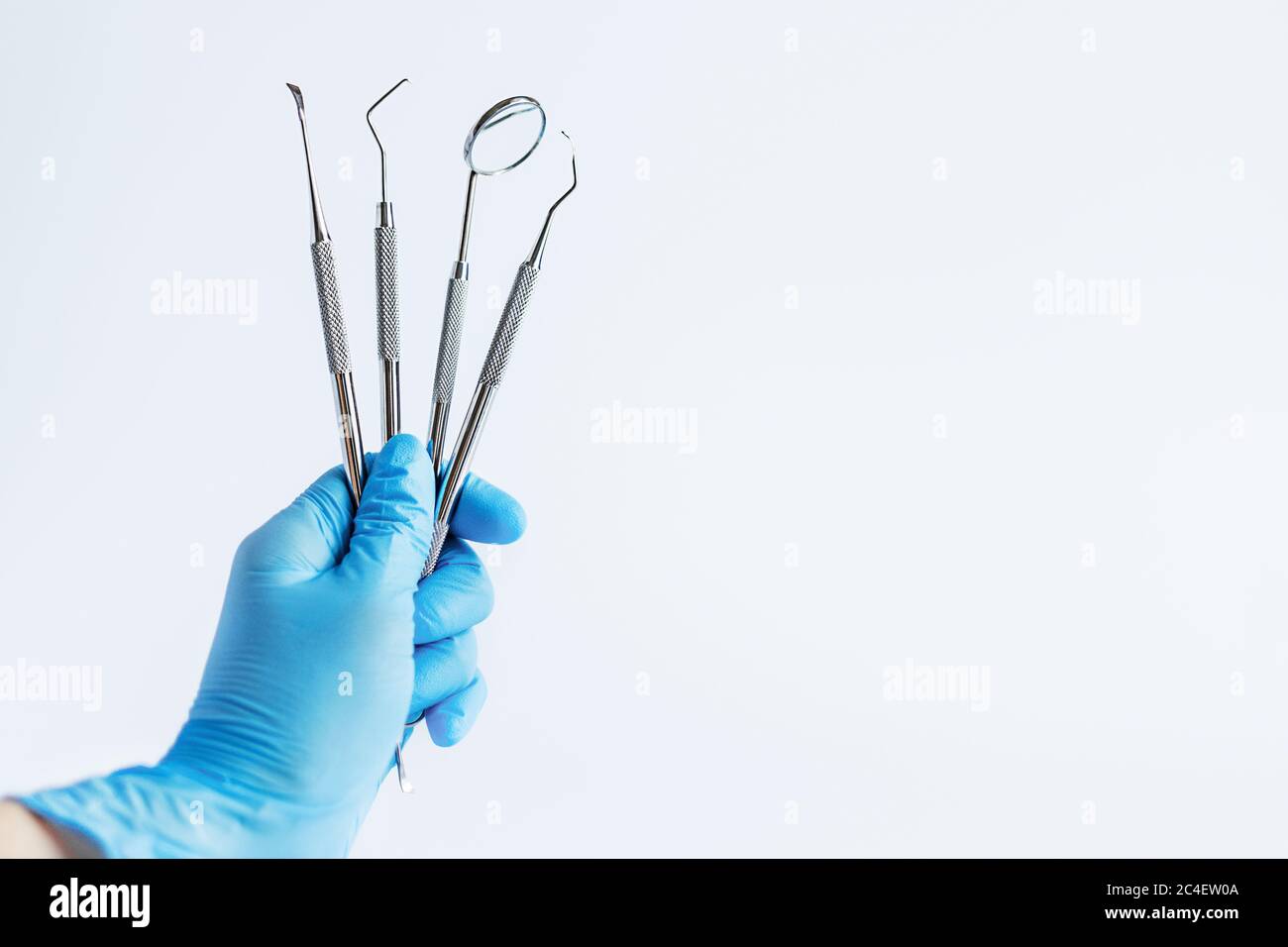 Doctor's hand holding dentistry tools for teeth dental care and ...