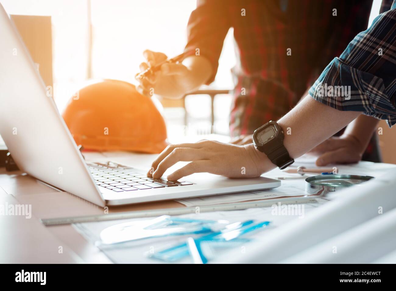 Two architects co-worker working together on project and using laptop checking data at office room. Stock Photo