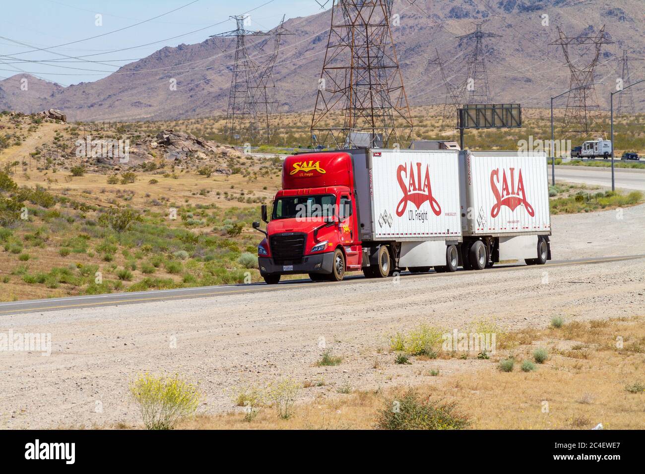 Apple Valley, CA / USA – May 16, 2020: A red and white Sala Freight semi-truck on a offramp of Interstate 15 in the Mojave Desert near the Town of App Stock Photo