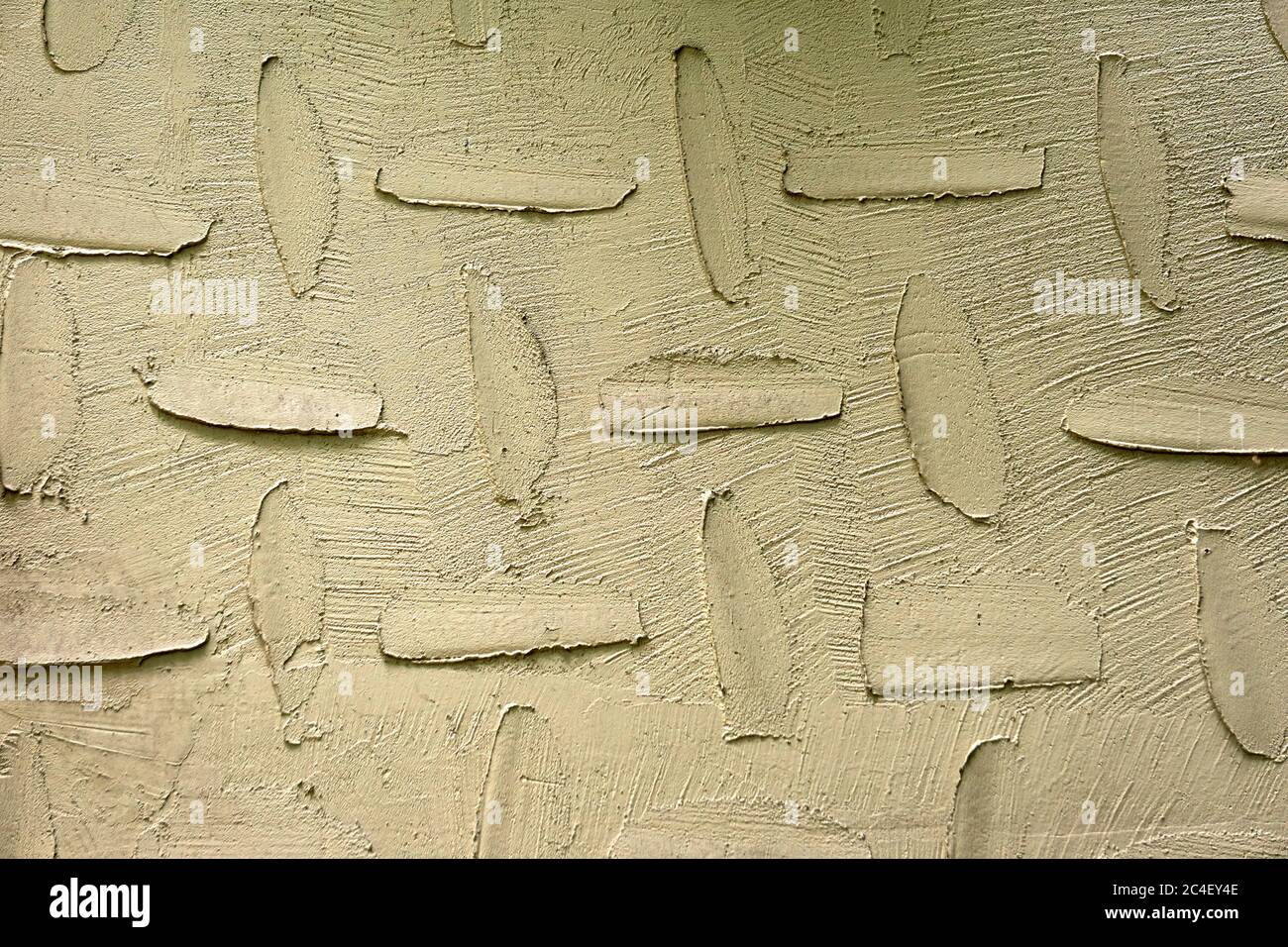 Closeup of trowel marks design on the beige stucco wall of a house Stock Photo